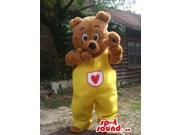 Brown Bear Forest Canadian SpotSound Mascot Dressed In Yellow Overalls With A Heart