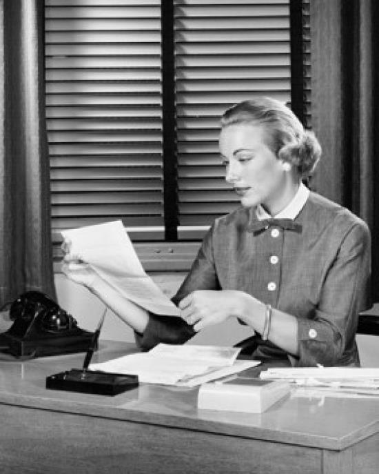 Close up of a businesswoman reading a document Poster Print (18 x 24)