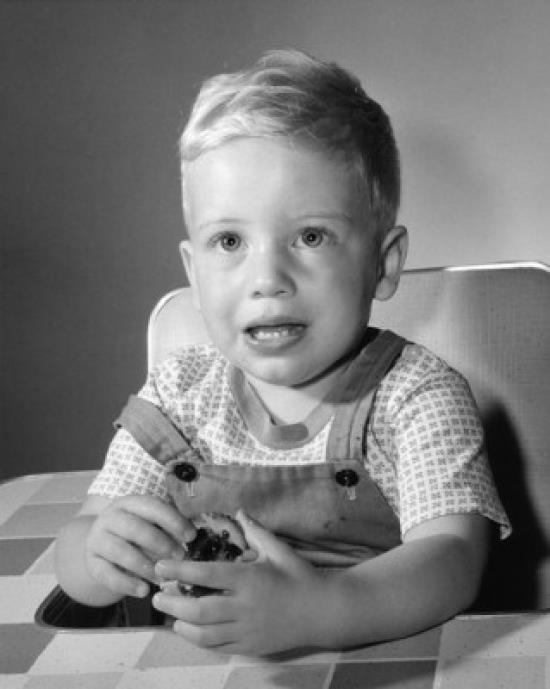 Little boy holding biscuit Poster Print (18 x 24)